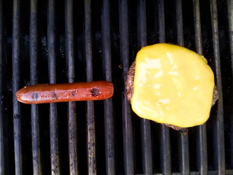 Directly Above Shot Of Cheeseburger And Hot Dog On Grill