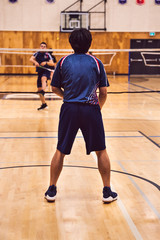 two boys playing badminton at the tournament
