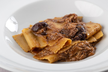 Traditional italian pasta. Homemade freshness pappardelle. Pasta with with a rabbit. Homemade delicious italian traditional pasta on wooden table for dinner. italian cuisine.