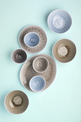 Beautiful blue and grey dinnerware, plates bowls on lilac background background table, top view, copy space, selective focus