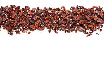 Cacao nibs isolated on a white background.