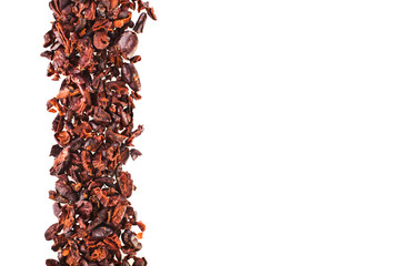 Cacao nibs isolated on a white background.
