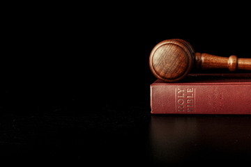 judge gavel with holy bible on black background