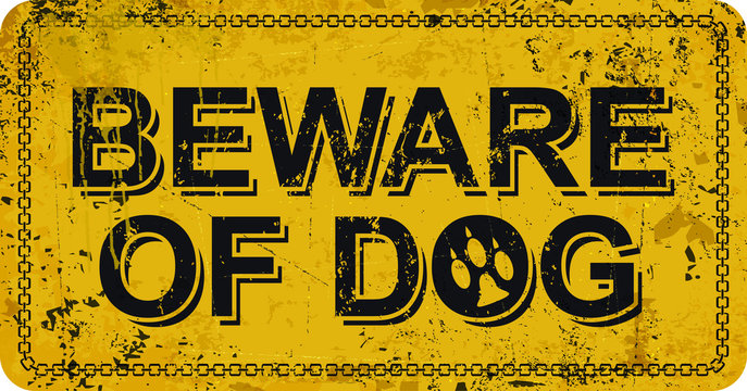 Beware of dog on yellow vintage rusty metal sign