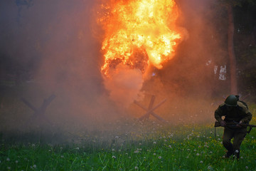 Fototapeta premium Running soldier on the battlefield and the fire of explosion