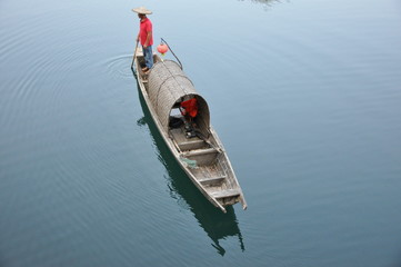 fishman and the boat floating over the water