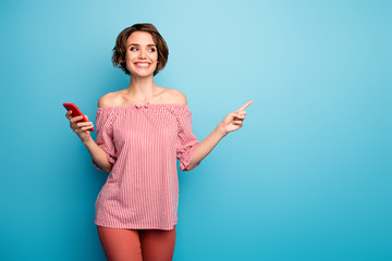 Photo of beautiful lady hold telephone indicate finger empty space advising sale smart phone prices...
