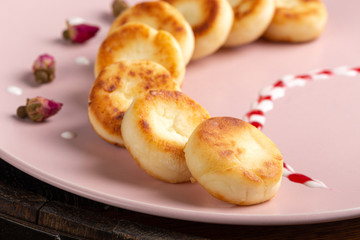 Cottage cheese pancakes, syrniki, curd fritters. Syrniki with fresh mint. Pancakes with cottage cheese on a plate sprinkled with powdered sugar. Homemade food