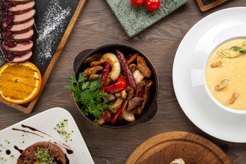 Home-made Pork Sausages in rustic pan. Sausages cooking in frying pan. Close up of fried sausages in frying pan over wooden background
