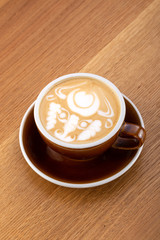a cup of hot latte coffee on aged brown wood, heart shape latte art, coffee lover concept. Hot coffee on a wooden table. a cup of hot coffee latte, beautiful latte art