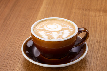 a cup of hot latte coffee on aged brown wood, heart shape latte art, coffee lover concept. Hot coffee on a wooden table. a cup of hot coffee latte, beautiful latte art