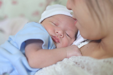 little newborn baby sleeping embrace on mother with love