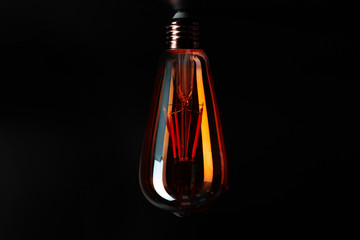 Light bulb on black background close up