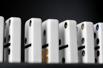 Domino game. Dominoes on a black table