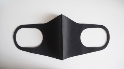 Black Mask help to protect Coronavirus virus and dust and other particle, put on white background.