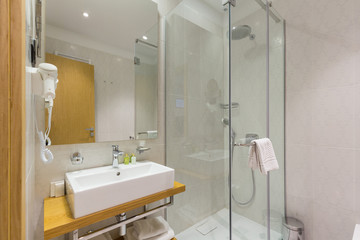 Interior of a luxury hotel bathroom with glass shower cabin