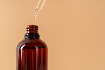 Cosmetic aromatic spa oil in brown glass bottle