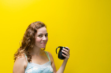 Blonde and Brazilian woman with a cup drinking coffee