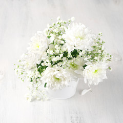 White flowers bouquet in bucket