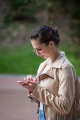 Business woman walking looking at the phone. Blogger, always online work 24 7. Vertical frame