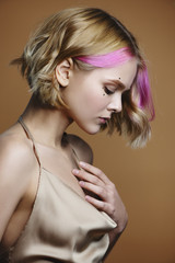 Side view of beautiful girl with pink hair.