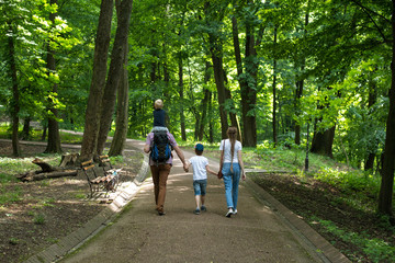 Family walks in the Park. Mom, dad and two children. Happy family