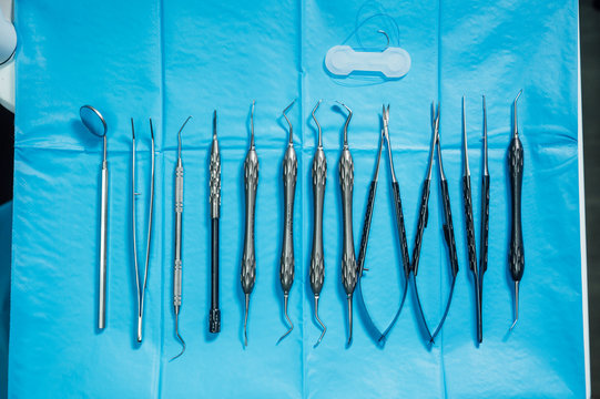 Detail of hand holding dental tools in dental clinic. Dental clinic.
