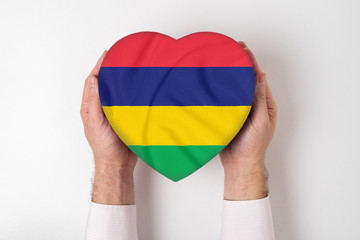 Flag of Mauritius on a heart shaped box in a male hands. White background