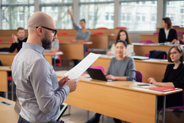 Lecturer and multinational group of students in an auditorium