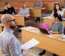 Lecturer and multinational group of students in an auditorium