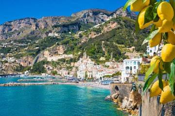 Beautiful Amalfi on hills leading down to coast, comfortable beaches and azure sea in Campania,...