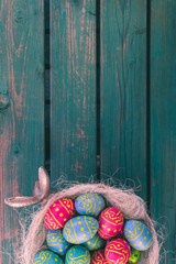 Easter bowl, chocolate eggs, green bench, Easter background