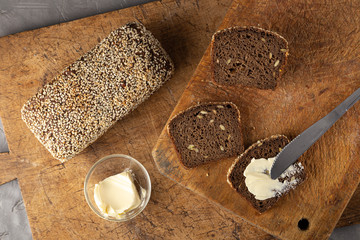 Fresh bread with butter, jam on a table. breakfast. Slice of bread with butter, jam on wooden table