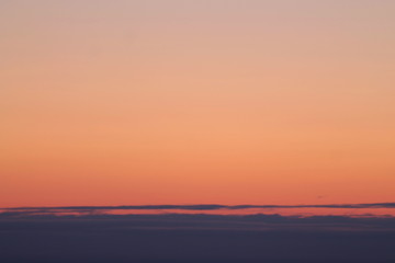 A beautifully backlit colorful sunset sky with the colors of sunrise and sunset.