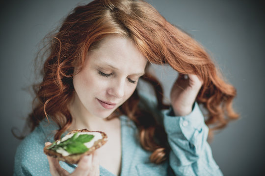 woman eating salad sandwich hearbs