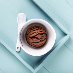 Homemade chocolate ice cream on light blue wooden background. Healthy summer food concept with copy space, top view