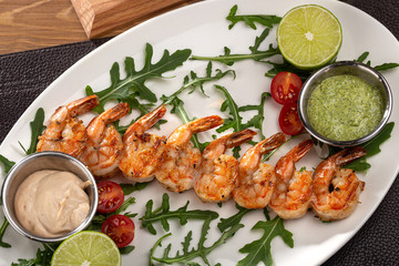 Grilled shrimp skewers. Seafood, shelfish. Shrimps with herbs, garlic and lemon. Barbecue srimps prawns.