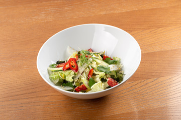 Spicy asian salad. Thai salad with greens, vegetables. Asian salad with chili, corn, cucumber, carrot, onion, soy, popular in the country Thailand. Indo-chinese cuisine hot dish with vegetables and ch