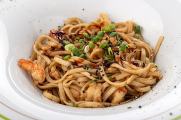 Stir fry with soba noodles, shrimps and vegetables. Asian healthy food, stir fried meal in bowls. Spicy noodles. Stir fry with soba noodles, shrimps (prawns) and vegetables. Indo-chinese cuisine hot d