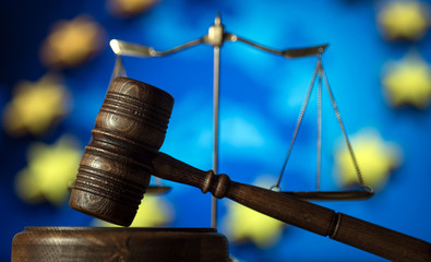 Law and Justice concept. UE flag background, place for typography. Courtroom Europe theme.
