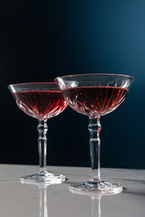 red wine in glasses on marble surface isolated on blue
