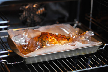 Pork is baked in the sleeve in the oven.