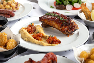 Grilled Food. Barbecue. Lamb rack roasted with herbs. Grilled roasted rack of lamb, veal with vegetables