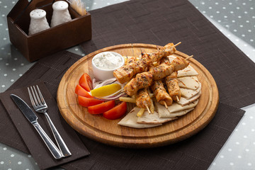 Barbecue. Barbecue grill with meat, closeup. Kebab with juicy meat. Barbecue skewers with juicy meat on plate. 