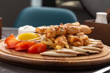 Barbecue. Barbecue grill with meat, closeup. Kebab with juicy meat. Barbecue skewers with juicy meat on plate. 