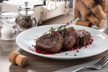 Juicy medium rare fillet steak mignon. Closeup view of delicious grilled beef medallions served on...