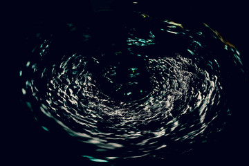 Dark abstraction with whirlpool of water