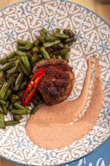 Juicy medium rare fillet steak mignon. Closeup view of delicious grilled beef medallions served on table. Barbecue. Barbecue grill with meat, closeup. fillet steak mignon