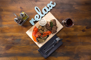 Barbecue. Barbecue grill with meat, closeup. Kebab with juicy meat. Barbecue skewers with juicy meat on plate. 