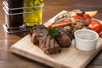 Barbecue. Barbecue grill with meat, closeup. Kebab with juicy meat. Barbecue skewers with juicy meat on plate. 